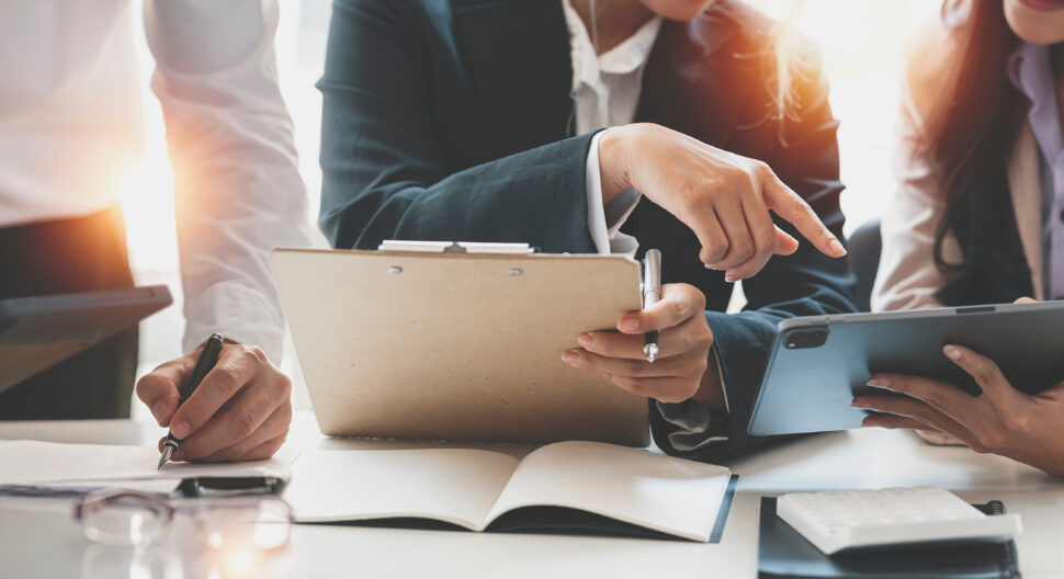 Cropped shot of diverse coworkers working together in boardroom, brainstorming, discussing and analyzing business strategy.